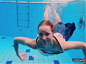 nubile nymph Avenna is swimming in the pool